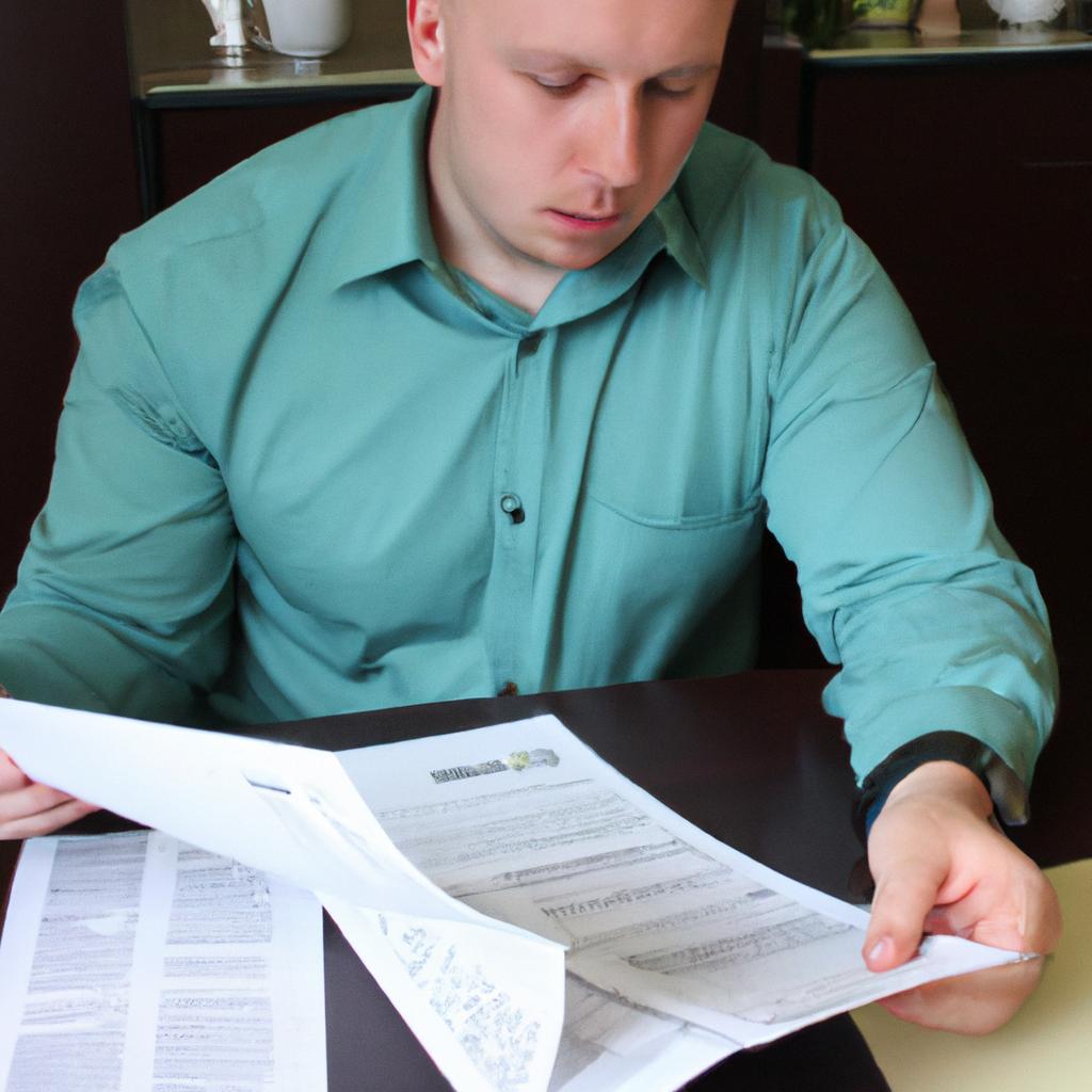 Person reviewing financial documents attentively